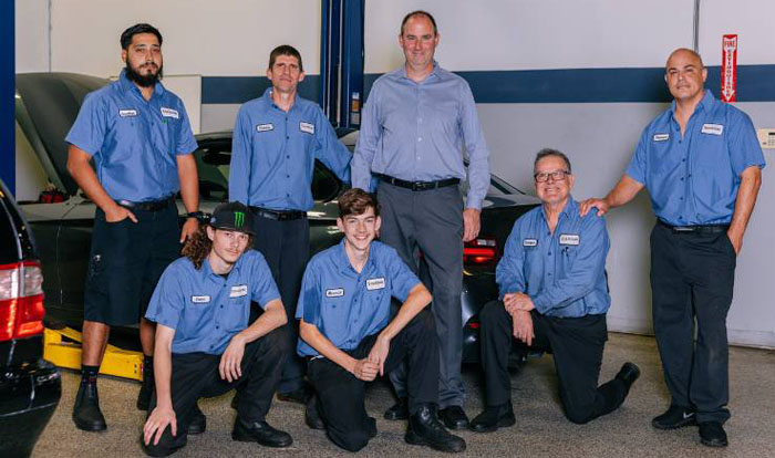 Chris Knuth pictured with six automotive students