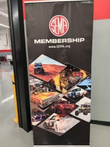 Entrance to the SEMA Garage Detroit ADAS Technology Center, showing large bold signage on a clean, modern facility wall with labeled garage bays.