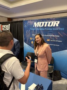 Nancy Conner speaking with an attendee at the MOTOR booth during Auto Care Connect 2025