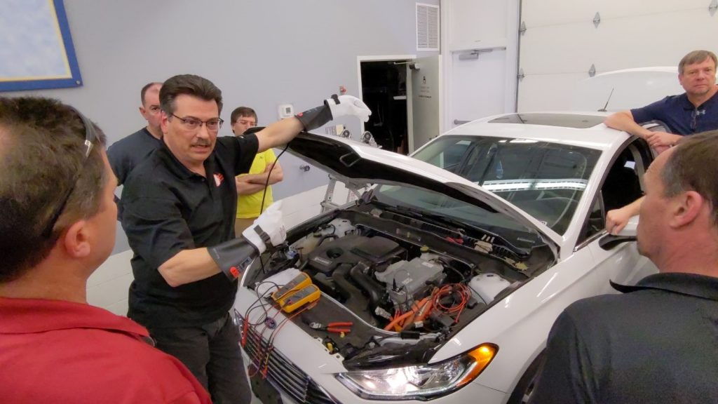 Trainer showing under the hood of an electric vehicle at an EVPRO+ Training session